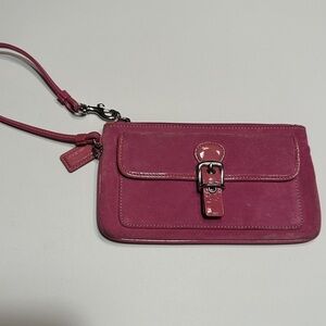 Cute pink suede Coach wristlet; has tag. Classic Coach lined interior.